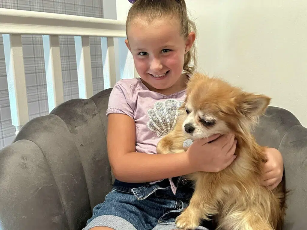 Jonathan's daughter holding Lady the Chihuahua